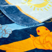 Close-up of blue and yellow character throw blanket fabric with Pikachu artwork