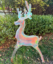 Iridescent reindeer balloon decoration standing in yard, antlers up