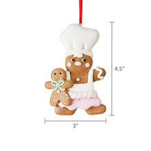 White-hatted gingerbread chef ornament with pink striped apron and cookie kid; 4.5 in