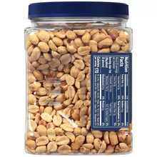 Dry roasted peanuts jar with blue label panel and peanuts visible through clear glass.