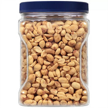 Dry roasted peanuts jar with peanuts filling clear glass and blue lid.