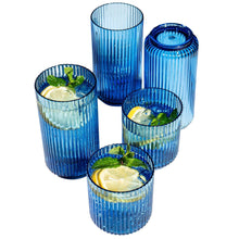 Blue ribbed plastic drink cups with lemon and herb garnish inside