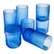 Blue ribbed plastic drink cups, assorted heights with one cup lying on its side