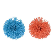 Fuzzy pom balls, one blue and one orange-red