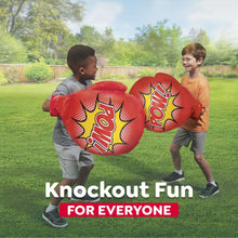 Inflatable oversized red boxing gloves on two kids for playful sparring