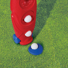 Red caddy and blue tee with two white golf balls on green textured play mat