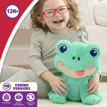 Green frog plush stuffed animal with star eyes held by laughing child in gray clothing