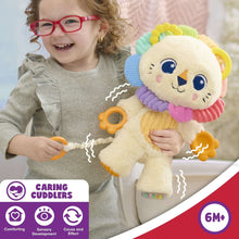 Lion plush with smiling face, rainbow ears, and rattle rings held by child