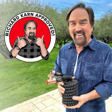 Pocket hose with copper connector and black patterned coil held in hand