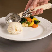 Thumb press portion scoop dispensing food onto a plate