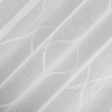 Sheer curtain fabric close-up with white trellis embroidery and wavy lines