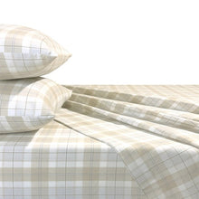 Beige plaid flannel sheets and pillowcases shown folded across a bed
