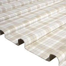 Beige plaid flannel sheet fabric draped in folds, showing its soft texture