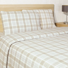 Beige plaid cotton flannel sheet set arranged on a bed with matching pillowcases