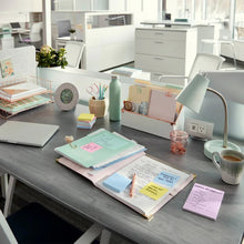 Canary yellow sticky note pads and notes arranged on an office desk
