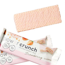 Strawberry creme protein energy bar pieces in pink wrappers with brand labels