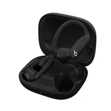 Powerbeats Pro 2 black earbuds in open charging case, earbuds seated in tray