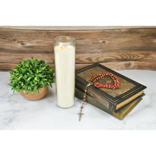 Prayer candle in clear glass with white wax, lit wick, full height