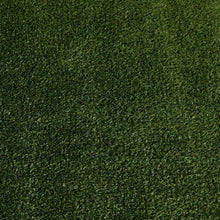 Artificial pet turf surface with dense short green grass blades