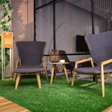 Artificial turf lawn mat with dense green blades under outdoor chairs