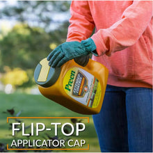 Orange weed preventer bottle held with flip-top applicator cap, green label panel.