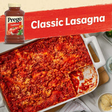 Prego Traditional Italian sauce over lasagna in a white baking dish with jar