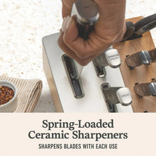 Knife block with built-in sharpeners and assorted knives with dark handles