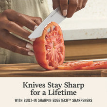 Chef knife slicing a tomato on a cutting board with built-in sharp edge