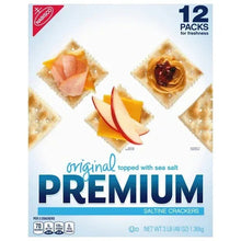 Box of saltine crackers, original topped with sea salt, shown with toppings
