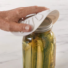 Silicone jar lid, white radial design placed on glass canning jar