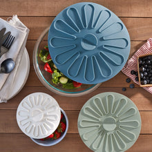Silicone food storage lid, blue with radial ridges and center vent
