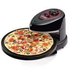 Rotating pizza oven with pizza on the circular tray, black housing