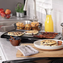 Presto electric griddle cooking surface with bacon, eggs, and hash browns