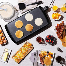 Presto electric griddle with four round batter cups on nonstick plate