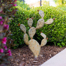 Prickly pear cactus metal sculpture, light beige pads with rust accents.