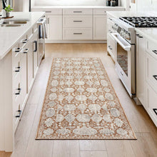 Area rug in kitchen with rust and gray medallion pattern on cream ground, bordered edge.