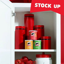 Pringles chip canisters stacked inside a kitchen cabinet shelf