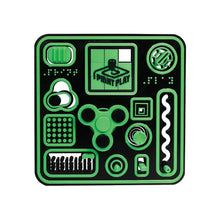 Green and black fidget board with raised tactile icons and molded shapes
