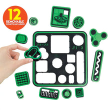 Hand holding a removable green fidget piece on a green and black board