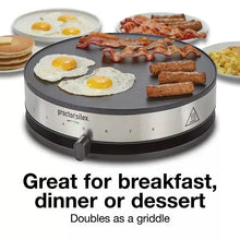 Crepe maker with crepes and breakfast items on the round cooking surface, silver base