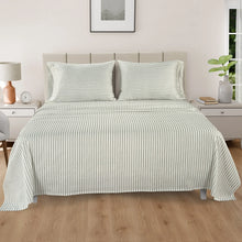 Striped bed sheet set laid on bed with matching pillowcases, light gray pinstripes