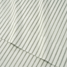 Close-up striped fabric sheet, light gray pinstripes on white background