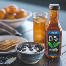 Pure Leaf sweet tea bottle beside ice, glasses, and a bowl of blueberries