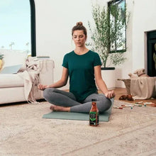 Unsweetened Pure Leaf tea bottle on yoga mat during relaxation