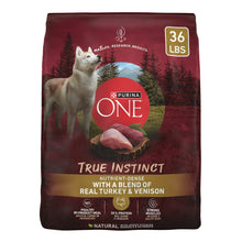 Dry dog food bag with Purina ONE True Instinct branding and 36 lb weight label