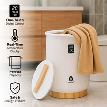 White towel warmer with wooden base, folded beige towel, and digital control display
