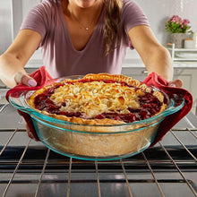 Clear deep glass casserole dish with baked casserole on oven rack