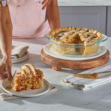 Round clear deep glass pie dish with baked tart and crust