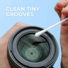Cotton swab tip touching a dark circular surface for precise cleaning