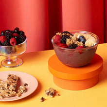 Granola bar pieces with chocolate chips and mixed berries in a bowl